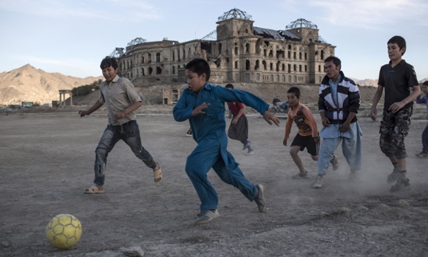 Children Playing Football In Rain