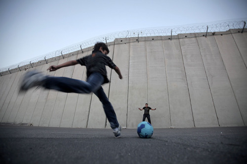 Children Playing Football In Rain